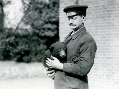 Un cuidador sostiene un cachorro de oso perezoso en el zoológico de Londres, agosto de 1921 de Frederick William Bond